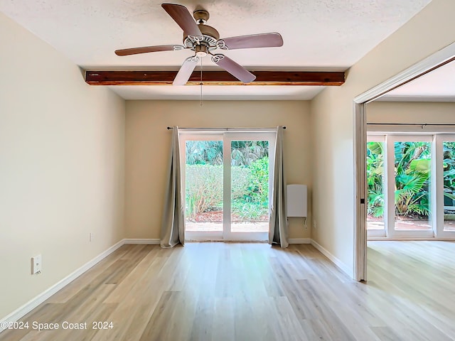 unfurnished room with light wood-type flooring, ceiling fan, and a healthy amount of sunlight