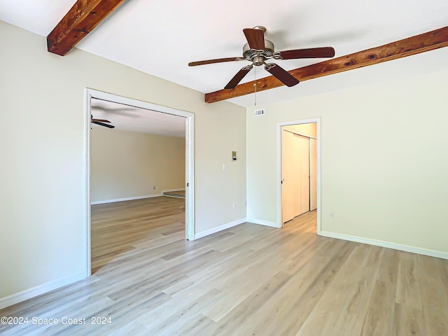 unfurnished bedroom with a ceiling fan, light wood-type flooring, beam ceiling, and baseboards