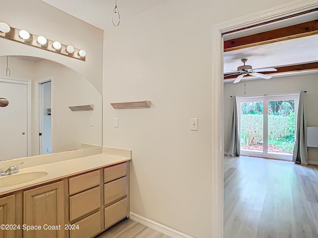 bathroom with a ceiling fan, wood finished floors, vanity, and baseboards