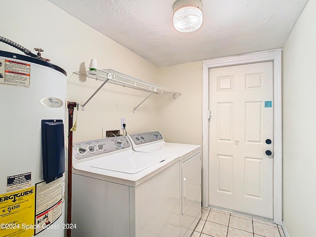 laundry area featuring laundry area, light tile patterned flooring, separate washer and dryer, and electric water heater