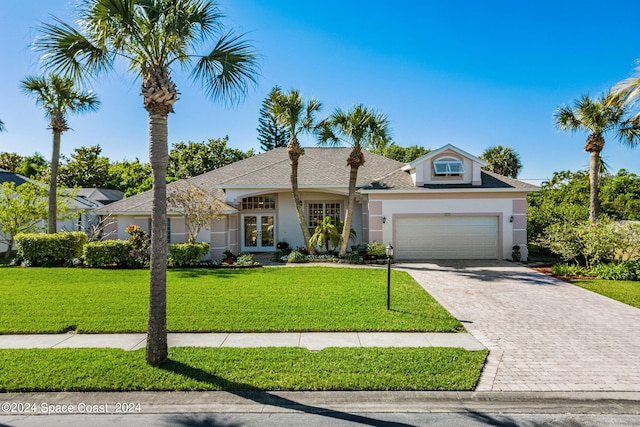 ranch-style house with a garage and a front lawn