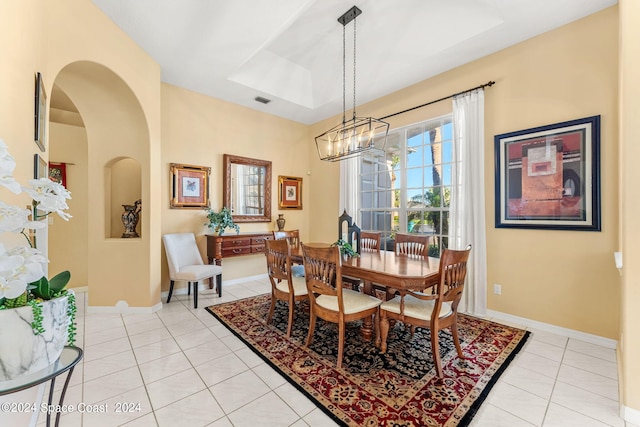 dining area with a notable chandelier and light tile patterned floors