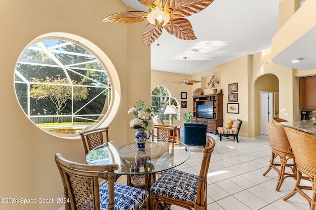 tiled dining space featuring ceiling fan