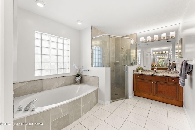 bathroom featuring tile patterned flooring, plenty of natural light, shower with separate bathtub, and vanity