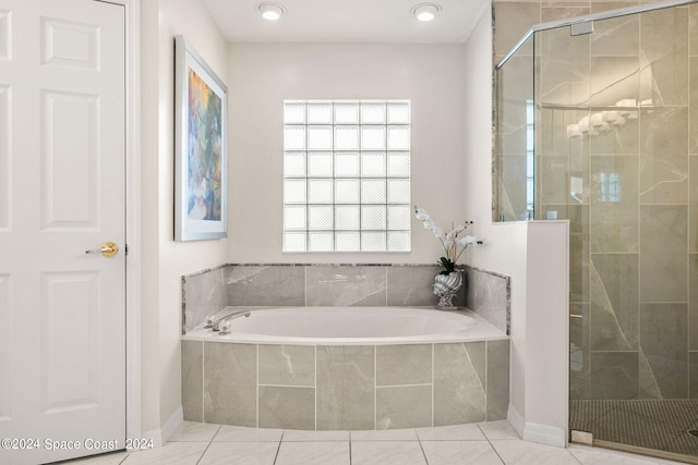 bathroom with separate shower and tub, a wealth of natural light, and tile patterned floors