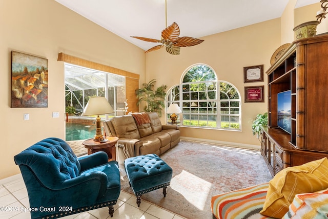 tiled living room featuring ceiling fan and vaulted ceiling