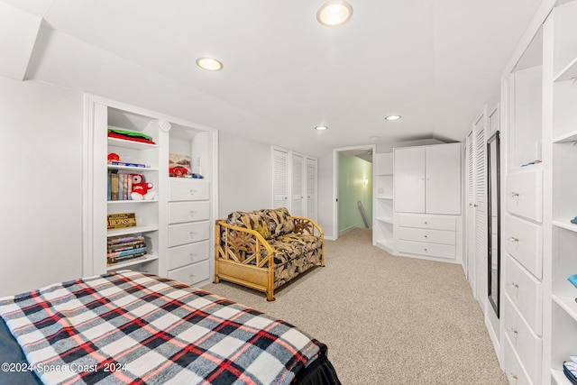 carpeted bedroom featuring multiple closets