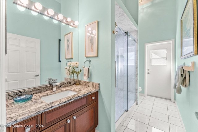 bathroom featuring vanity, toilet, a shower with shower door, and tile patterned floors