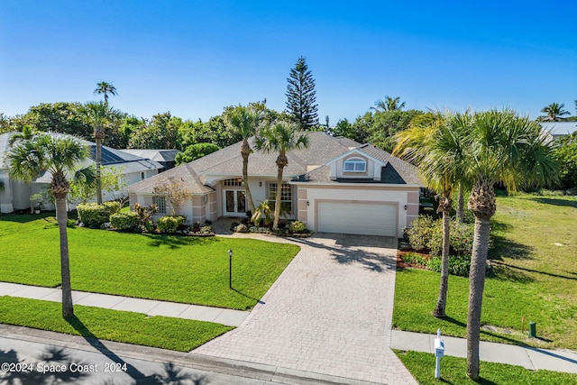 view of front of house with a garage and a front lawn