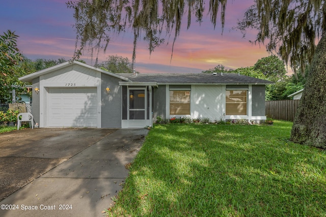 ranch-style house with a yard and a garage