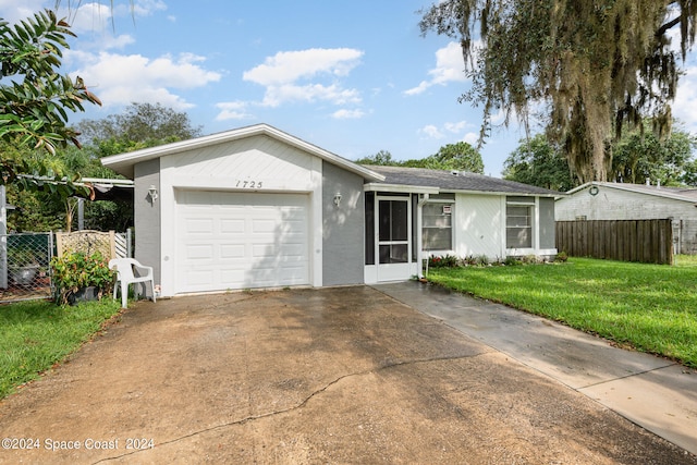 single story home featuring a front lawn and a garage