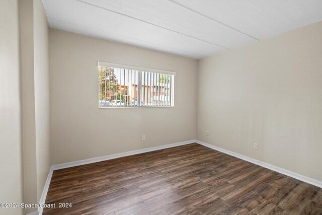 empty room with dark wood-type flooring