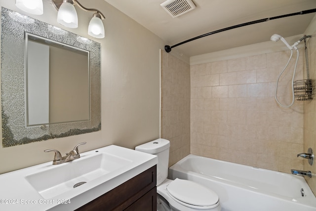 full bathroom featuring tiled shower / bath combo, vanity, and toilet