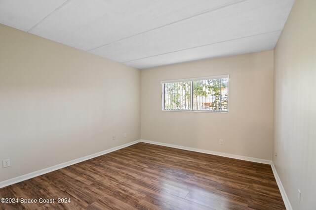 spare room with wood-type flooring