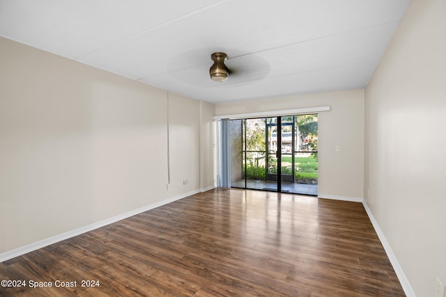 unfurnished room with ceiling fan and dark hardwood / wood-style floors