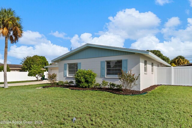 view of property exterior with a yard