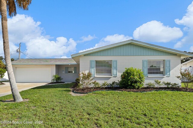 ranch-style house with a garage and a front lawn