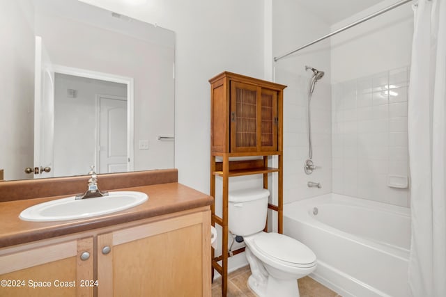 full bathroom featuring vanity, toilet, tiled shower / bath combo, and tile patterned floors