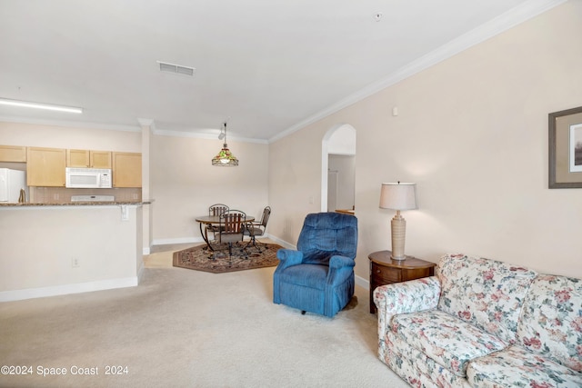 sitting room with light carpet and ornamental molding