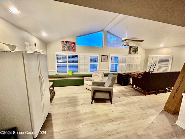 living room featuring ceiling fan, light hardwood / wood-style floors, lofted ceiling with beams, and a textured ceiling