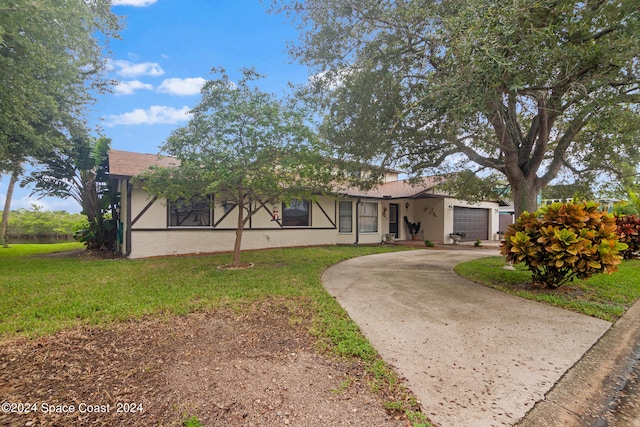 view of front of home with a garage and a front lawn