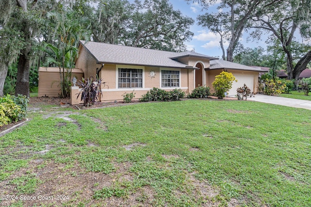 single story home with a garage and a front yard