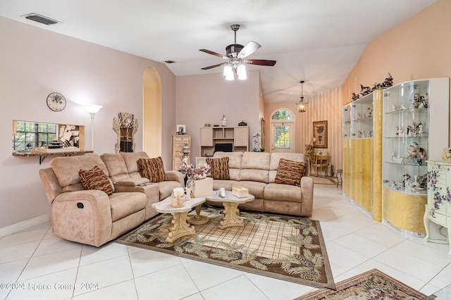 tiled living room featuring ceiling fan, plenty of natural light, and vaulted ceiling