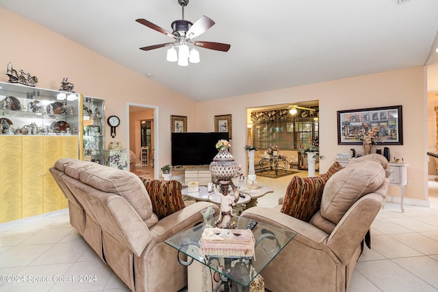 tiled living room featuring ceiling fan and vaulted ceiling