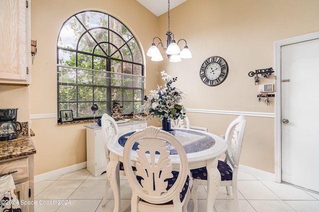 tiled dining room featuring a chandelier