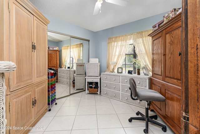 office area with ceiling fan, light tile patterned flooring, and a textured ceiling