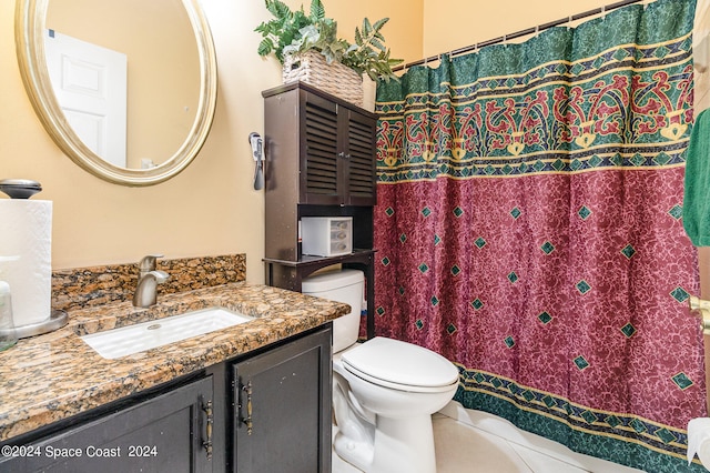 bathroom with tile patterned floors, toilet, and vanity