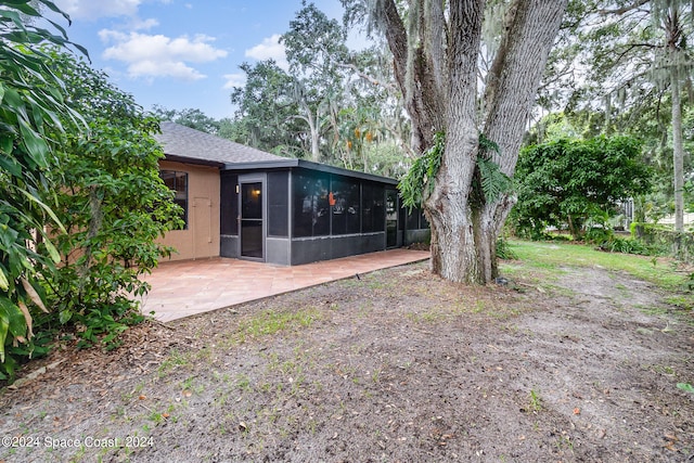 back of house featuring a patio and a sunroom