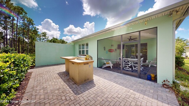 view of patio / terrace featuring area for grilling and ceiling fan