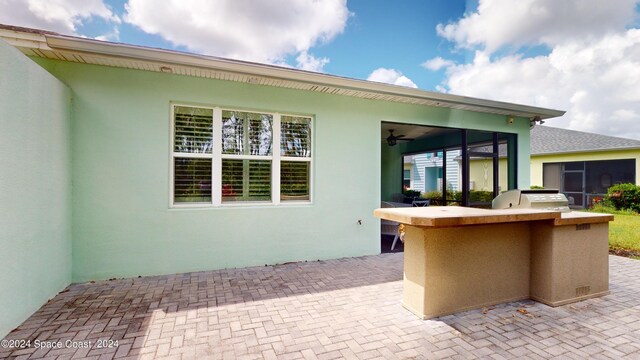 view of patio / terrace featuring a grill, an outdoor kitchen, and exterior bar