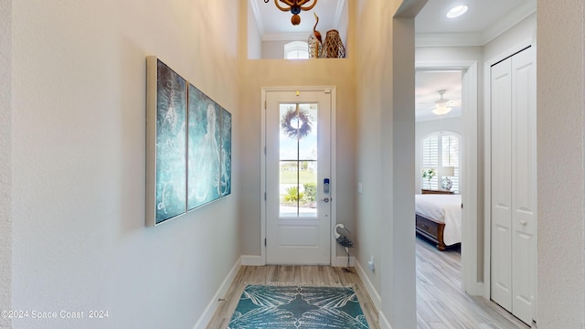 interior space with plenty of natural light, ornamental molding, and light wood-type flooring