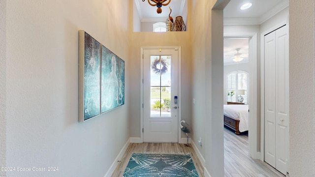 362 Tiki Ter, Daytona Beach, FL 32124 - doorway to outside featuring baseboards, light wood-style flooring, and ornamental molding