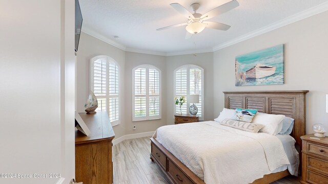 bedroom with crown molding, ceiling fan, and light hardwood / wood-style floors