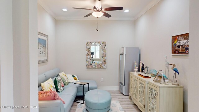 living room featuring ornamental molding, ceiling fan, and light hardwood / wood-style floors