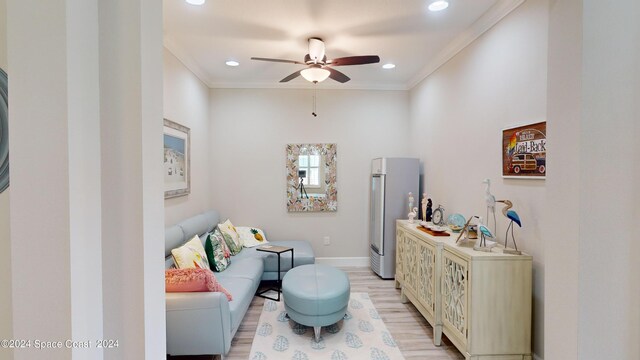 interior space featuring crown molding, ceiling fan, and light wood-type flooring