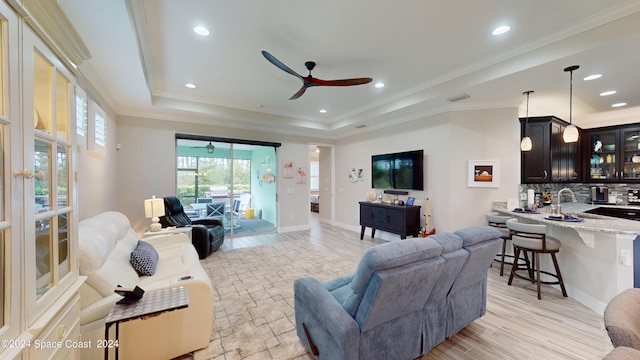 362 Tiki Ter, Daytona Beach, FL 32124 - living area featuring a tray ceiling, wet bar, crown molding, baseboards, and ceiling fan