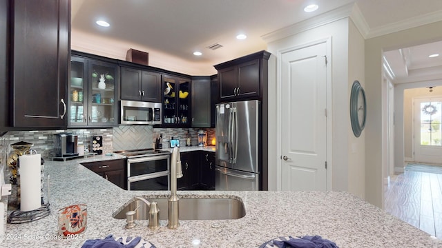 362 Tiki Ter, Daytona Beach, FL 32124 - kitchen featuring ornamental molding, light stone countertops, tasteful backsplash, appliances with stainless steel finishes, and glass insert cabinets