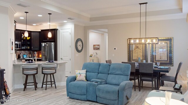 living room featuring light hardwood / wood-style floors and ornamental molding