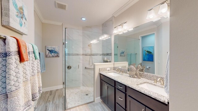 bathroom featuring crown molding, vanity, hardwood / wood-style floors, and an enclosed shower