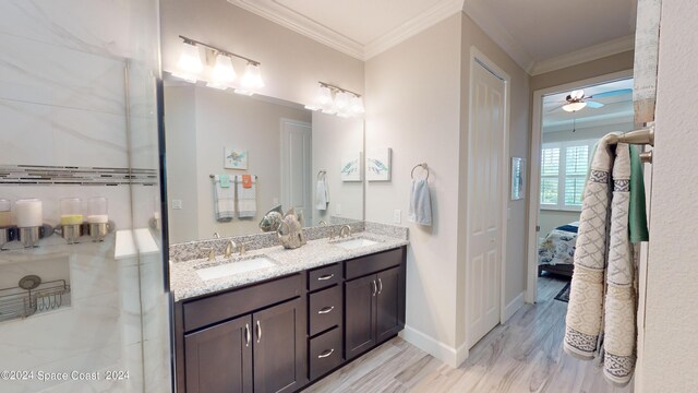 bathroom with ceiling fan, crown molding, wood-type flooring, and vanity