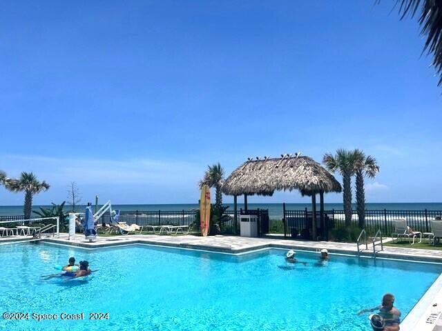 view of pool with a water view