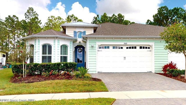 362 Tiki Ter, Daytona Beach, FL 32124 - view of front facade featuring a garage, a front yard, roof with shingles, and decorative driveway