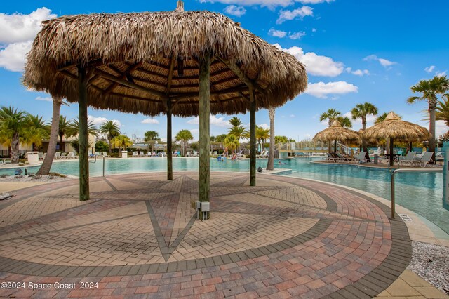 view of community with a swimming pool, a patio, and a gazebo