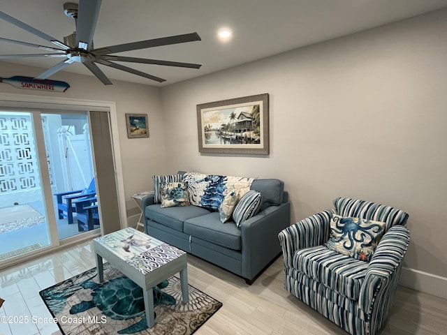 living room featuring ceiling fan and light hardwood / wood-style flooring