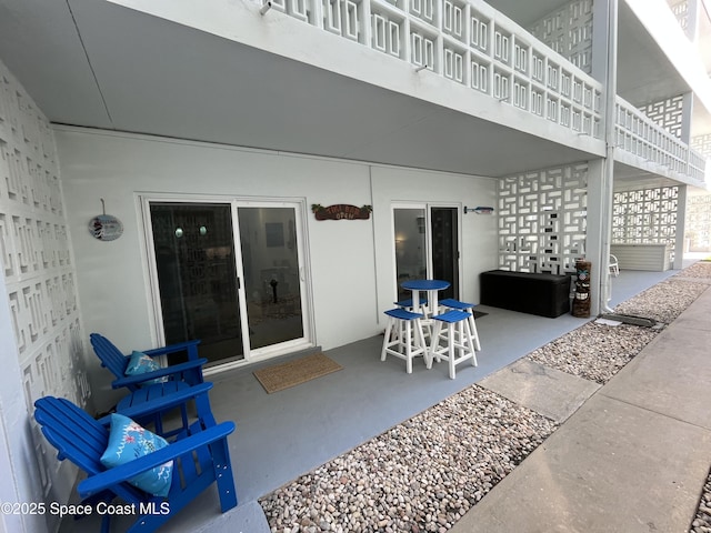 view of patio featuring a balcony