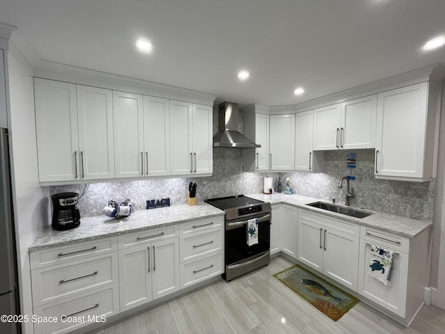 kitchen with white cabinetry, wall chimney range hood, electric range, and sink